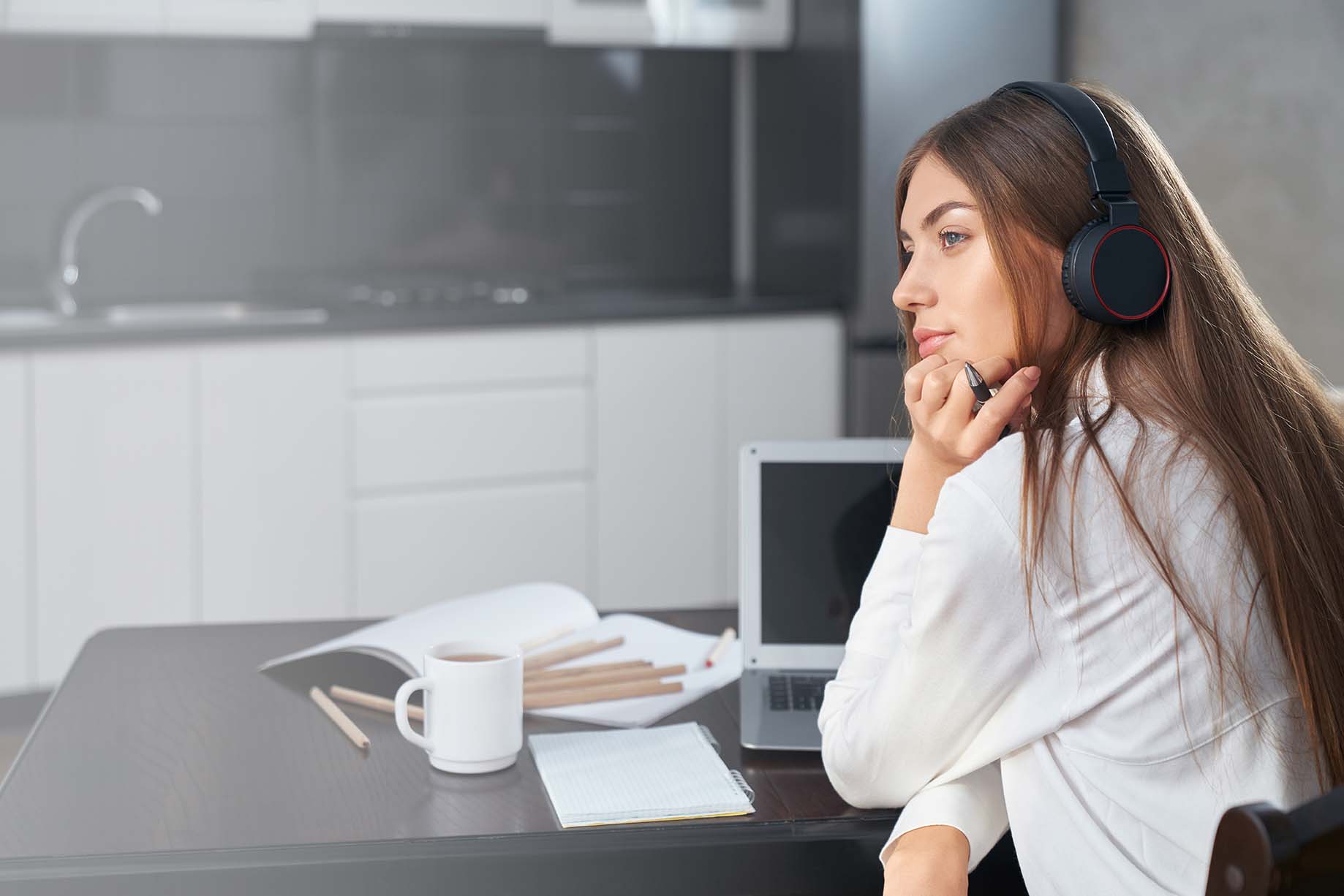 thoughtful student using laptop and headphones for 2021 05 07 23 15 28 utc